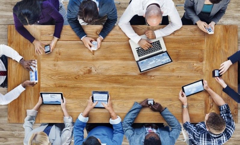 People around a desk aerial view